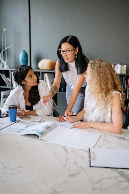 Free Women at the Meeting Table Having a Discussion Stock Photo